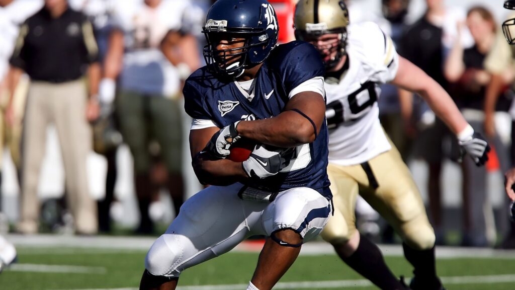 Two NFL players during a match in the sun.